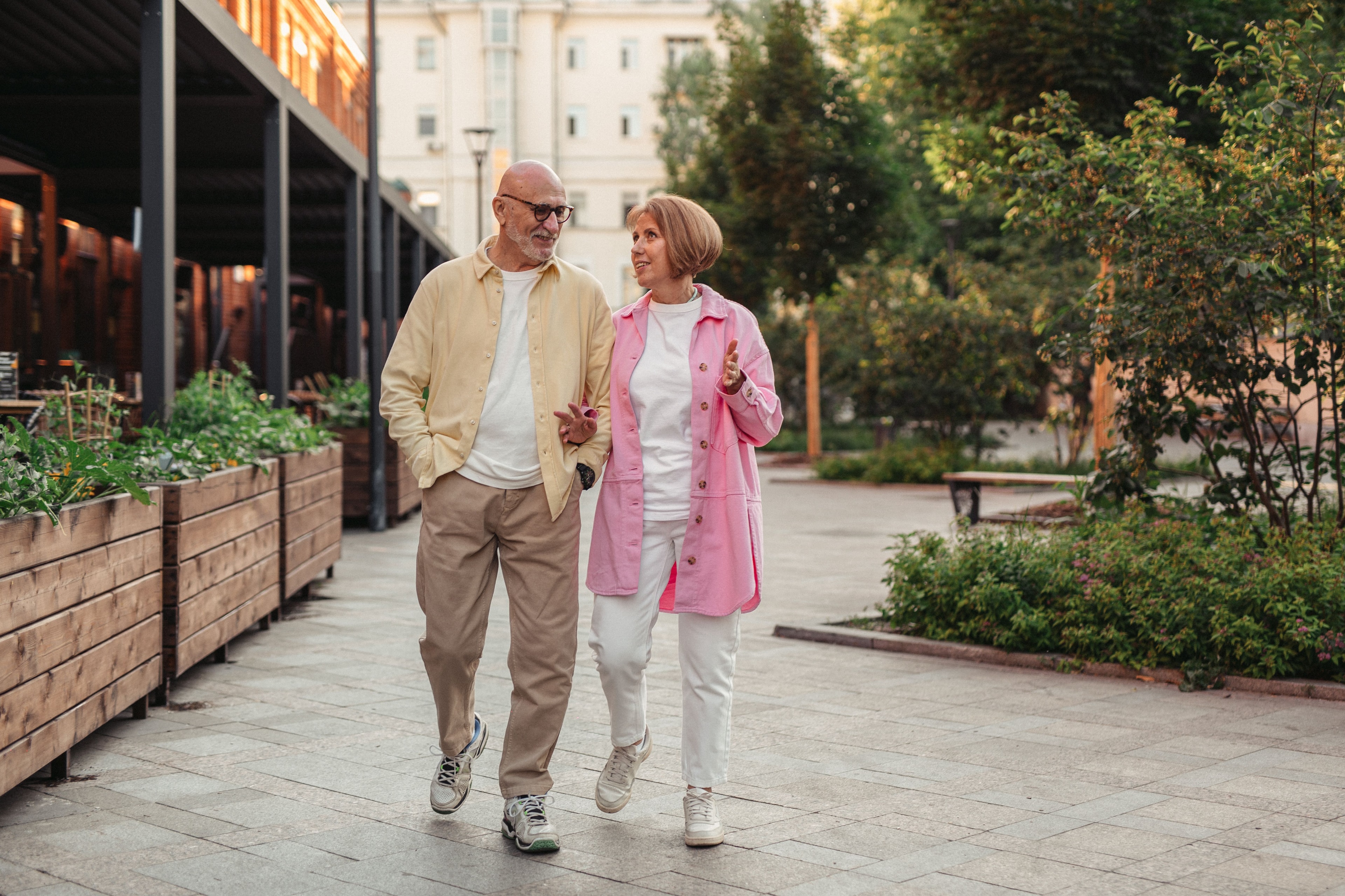An active older couple walking together outdoors