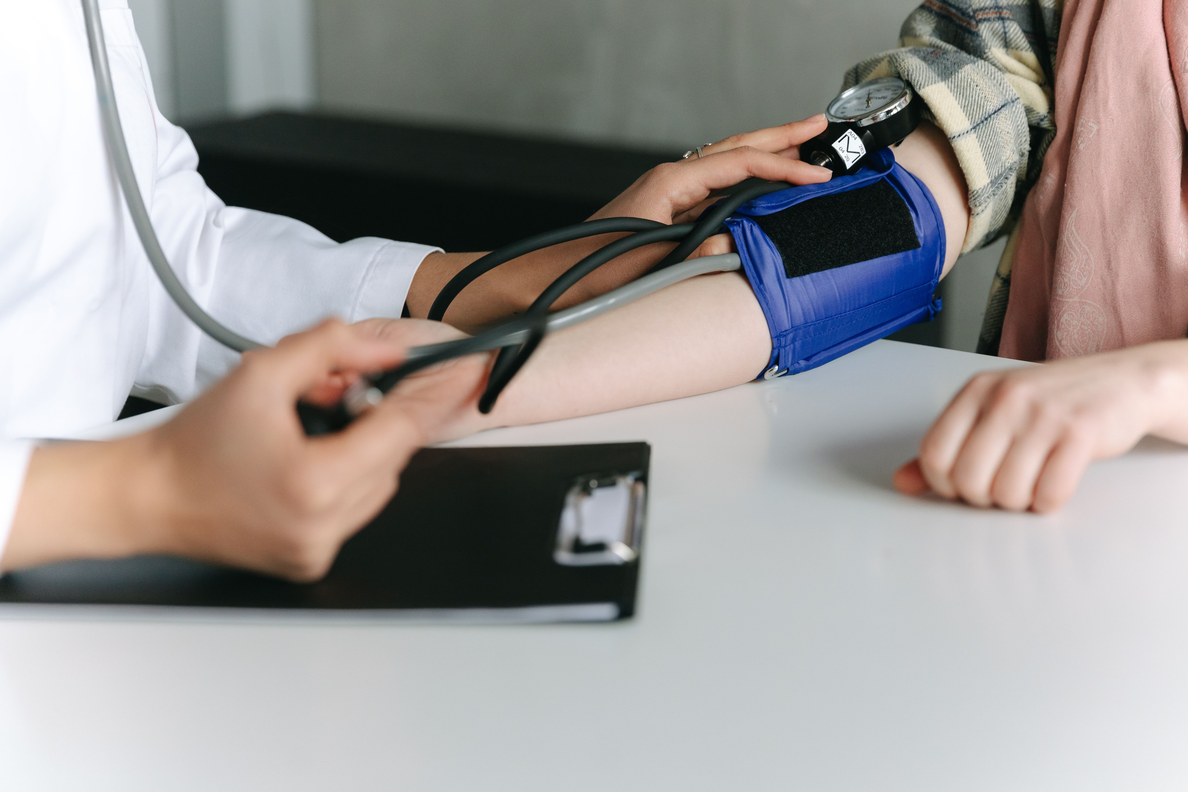 Clinician checking a patient's blood pressure during a vascular evaluation