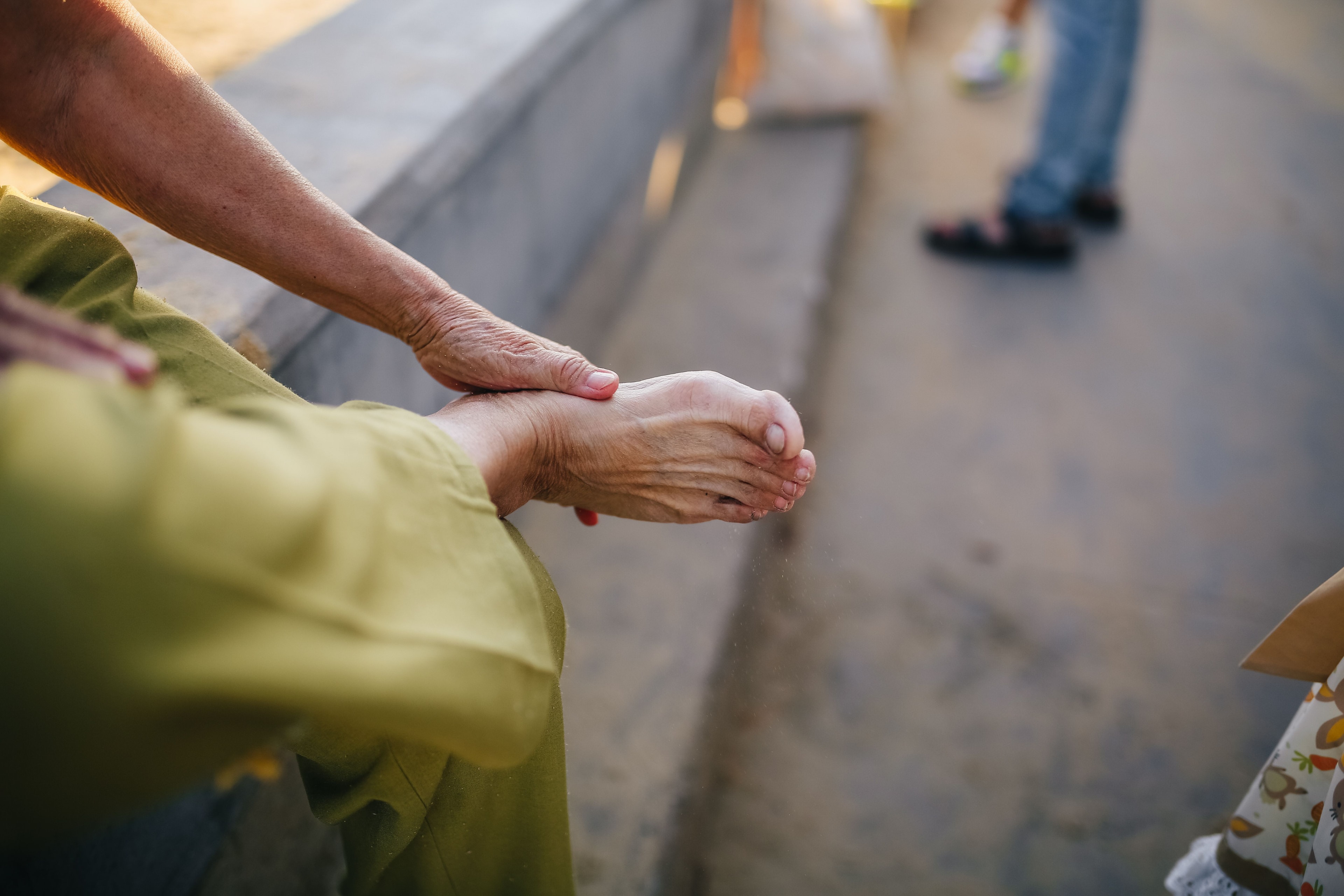 Patient holding a painful lower leg and foot