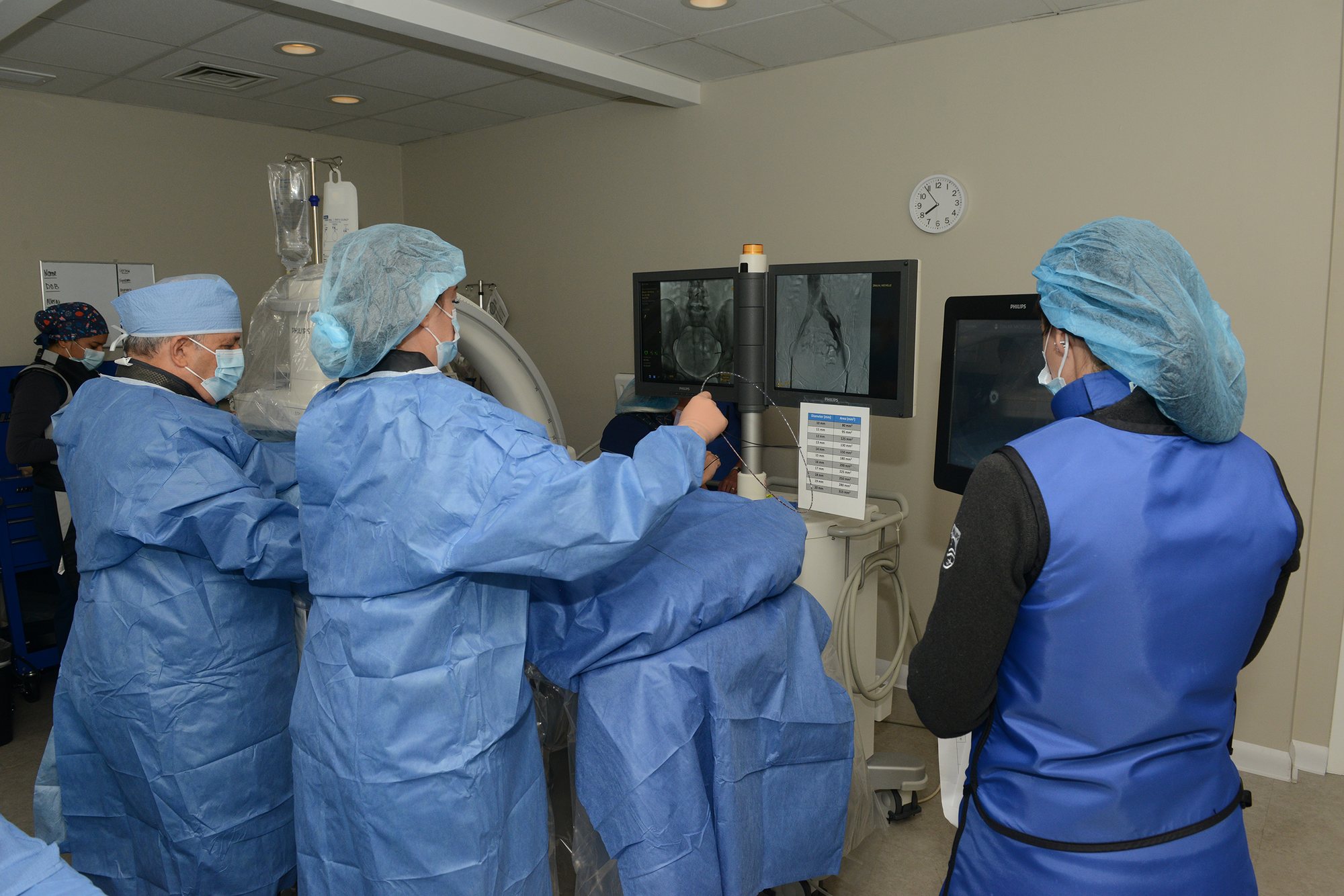 The Illiana team reviewing live vascular imaging in the procedure suite